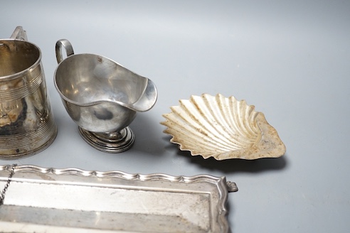 A George V silver sauceboat, an Edwardian silver pen tray and three other items including shell butter dish, 18oz.